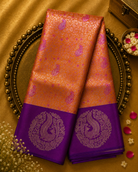 Bright Orange Silk Saree with Purple Motifs & Peacock Zari Border